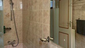 A modern bathroom with a shower, a sink, and a mirror. - Séjour en Pavillon Proche des Transports et des Évènements (Aulnay-sous-Bois)