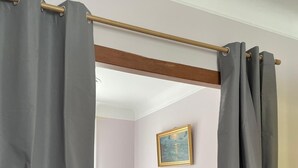 A bedroom with a bed, a bedside table, a lamp, and a painting on the wall. - Séjour en Pavillon Proche des Transports et des Évènements (Aulnay-sous-Bois)