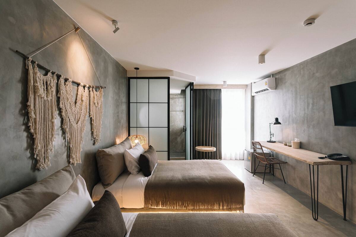 Une chambre à coucher moderne avec un grand lit, un bureau et une chaise.