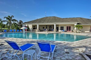 A swimming pool with blue lounge chairs and a covered seating area. - 13 Mi to Disney Parks: Family Villa w/ Heated Pool (Kissimmee)