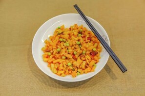 A bowl of food with chopsticks on a table. - Guangzhou Jiulong Hotel (Sansui Fuzheng West Road Branch) (Sansui)