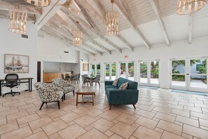 A spacious lobby with a high ceiling, modern furniture, and large windows. - I-250 - Peaceful Views & Close to Beach -Sleeps 6 (Naples)