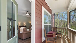 A wooden deck with a table and chairs, a sofa, and a ceiling fan. - Babbling Brook-New construction (Maggie Valley)