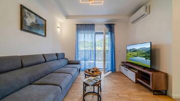 Family Apartment, 2 Bedrooms, Balcony (Modern Apartment With Balcony And) | Living area | Flat-screen TV