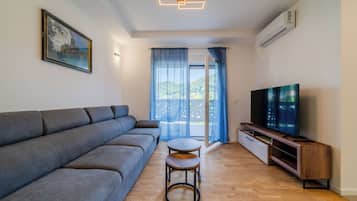 Family Apartment, Multiple Bedrooms (Modern Apartment With Balcony And) | Living area | Flat-screen TV
