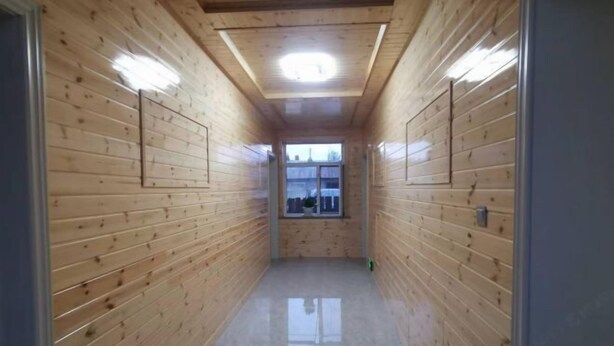 A narrow hallway with wooden walls and a ceiling light. - Taoran Farmhouse (Mohe)