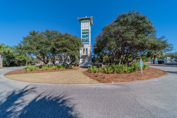 A white building with a green roof and a tower-like structure in the center. - Sea La Vie 1 Bedroom Condo by RedAwning (Panama City Beach)