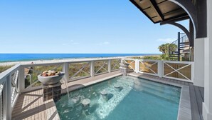 A rooftop pool with clear blue water, a white railing, and a view of the ocean. - "Wait and Sea" New Beachfront Home in PCB with Private Pool and Beach Access! (Panama City Beach)