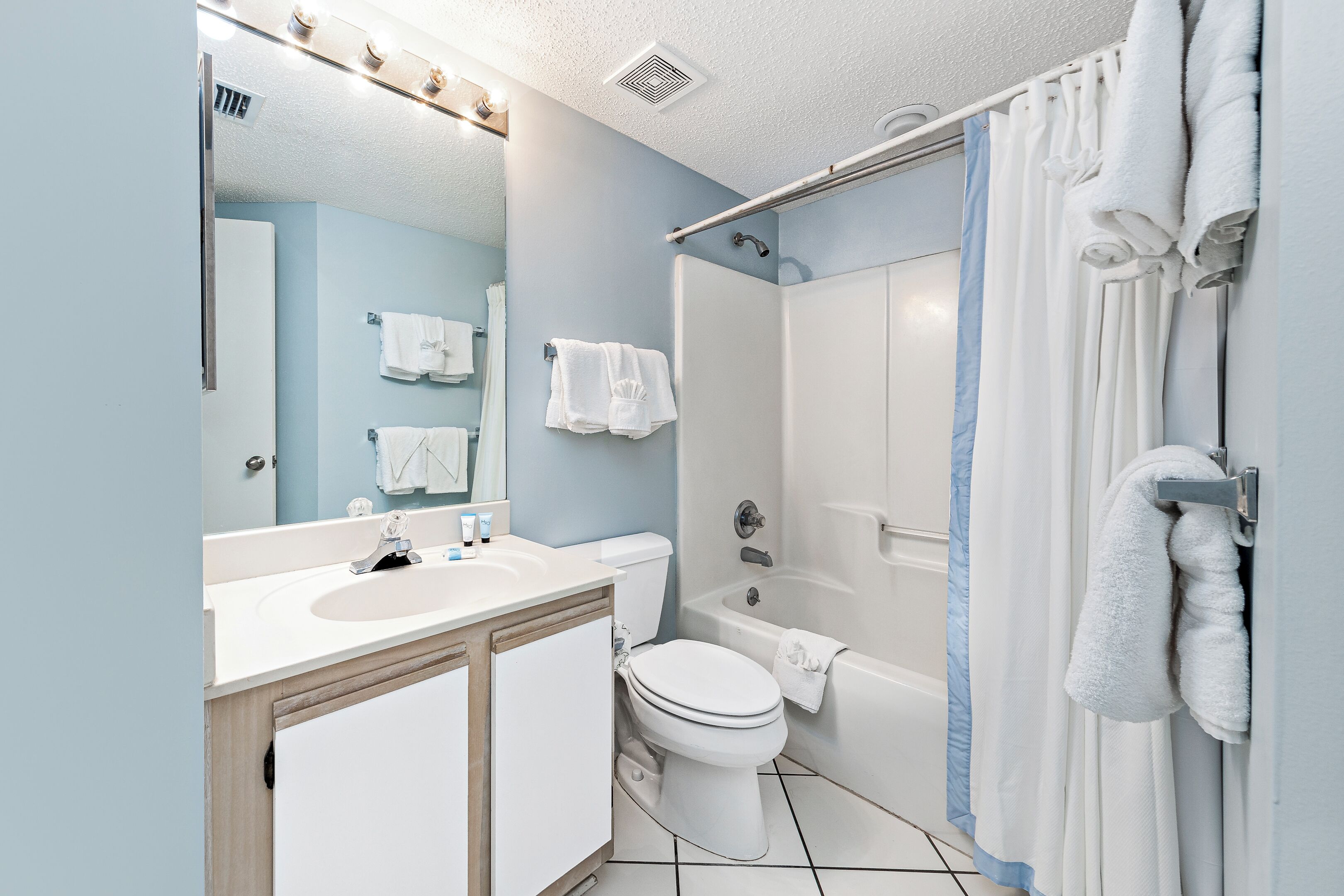 A bathroom with a sink, toilet, and bathtub.