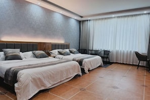 A hotel room with two beds, a small table, a chair, and a large window with curtains. - Shangzhi Longmen Hotel (Shangzhi)