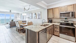 A modern kitchen with wooden cabinets, a built-in microwave, and a stainless steel stove.