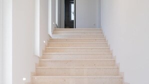 A staircase leading to a dark doorway, with a modern light fixture above. - Luxury Villa Morus with pool 50m2, gym, family, bbq (Murvica)