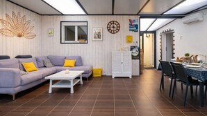 Una sala de estar moderna con sofá, mesa de centro y comedor.