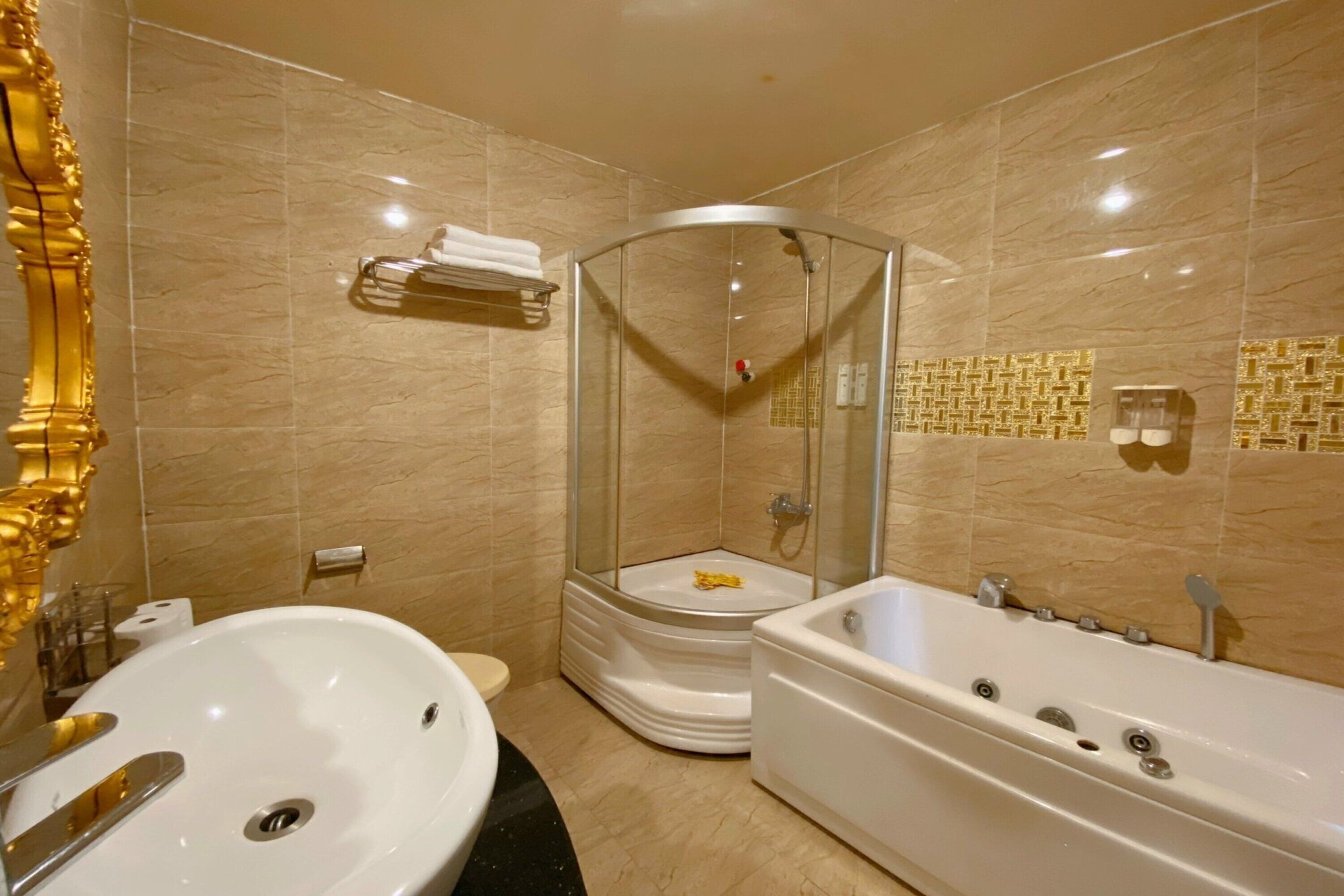 A modern bathroom with a large bathtub, a glass-enclosed shower, and a vanity with a sink.
