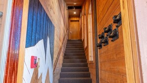 A wooden staircase with a fire alarm on the left. - #9 New! 3 bedroom Apartment in Town (Mammoth Lakes)