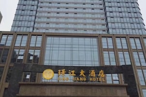 Um hotel com fachada moderna, exibindo uma placa grande com caracteres chineses.