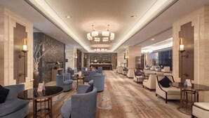 A spacious lobby with a central seating area, a reception desk, and a chandelier. - Jing Jiang Hotel (Lianjiang)