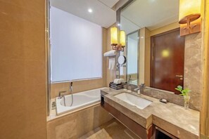 A modern bathroom with two sinks, a large mirror, and a wooden door. - Luling Hotel (Ji'an County)