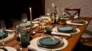 A dining table set with plates, glasses, and candles, suggesting a formal dining experience. - La Auxiliadora - Classic Mountain Chalet (Montecito)