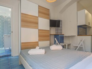 Relax in a stylish room with a large bed, flat-screen TV, and modern amenities.