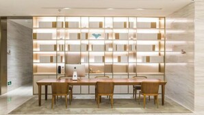 A modern conference room with a long table, three chairs, and a wall with illuminated panels. - JI Hotel (Fuzhou Gushan Fuma Road) (Fuzhou)