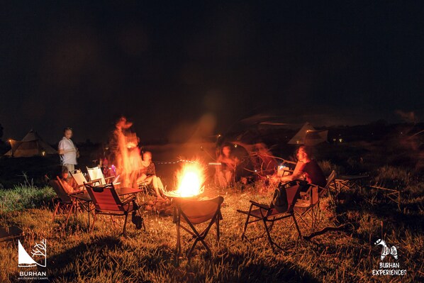 A campsite with tents and a campfire.