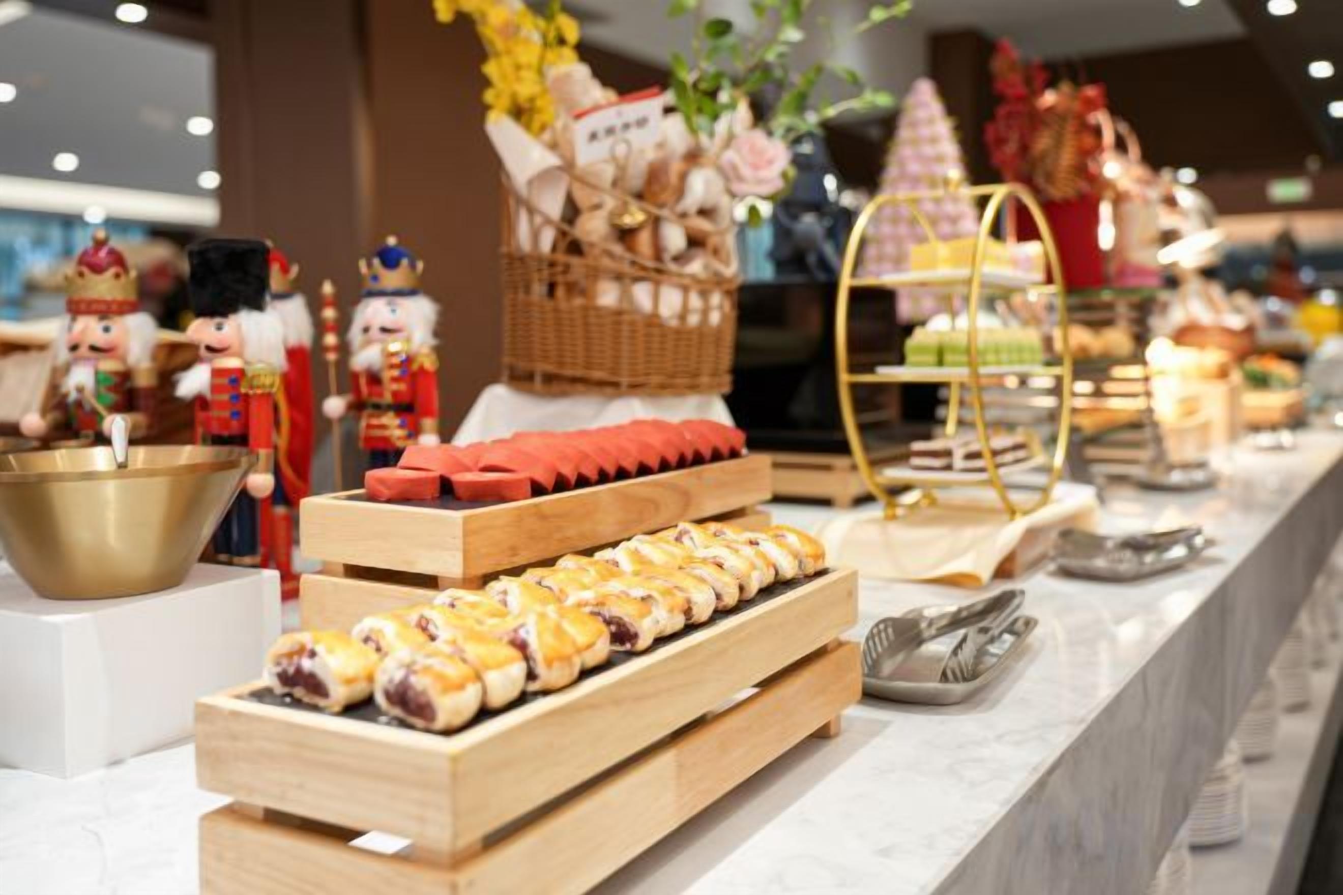 A buffet setup with various food items and decorative elements.
