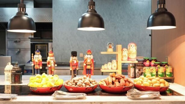 A buffet table with various food items and nutcracker figurines. - Guomao Boutique Hotel (Zhangjiagang)