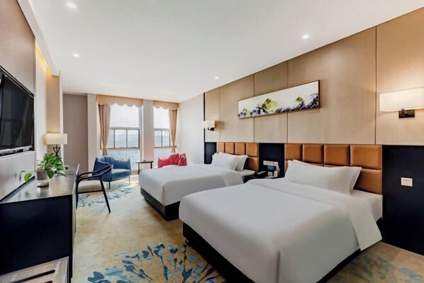 A hotel room with two beds, a desk, a TV, and a window with curtains. - Hsh Cozy Hotel (Wuhu)