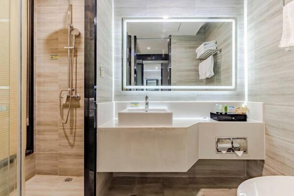 A modern bathroom with a glass-enclosed shower, a large mirror with integrated lighting, a white sink, and a vanity with storage. - Hsh Cozy Hotel (Wuhu)