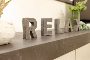 A countertop with the word "RELAX" spelled out in stone letters. - Sardinia RE - Melany 22 (Alghero)
