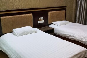 Two single beds with white linens, a wooden headboard, and a nightstand between them. - Chongren Laowu Business Hotel (Chongren)
