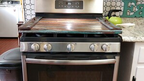 A stainless steel oven with a digital control panel, a built-in microwave, and a stainless steel range hood. - OLD DALLAS INN Charming 4-bedroom house, LARGE Dog friendly Backyard  (Elm Mott)