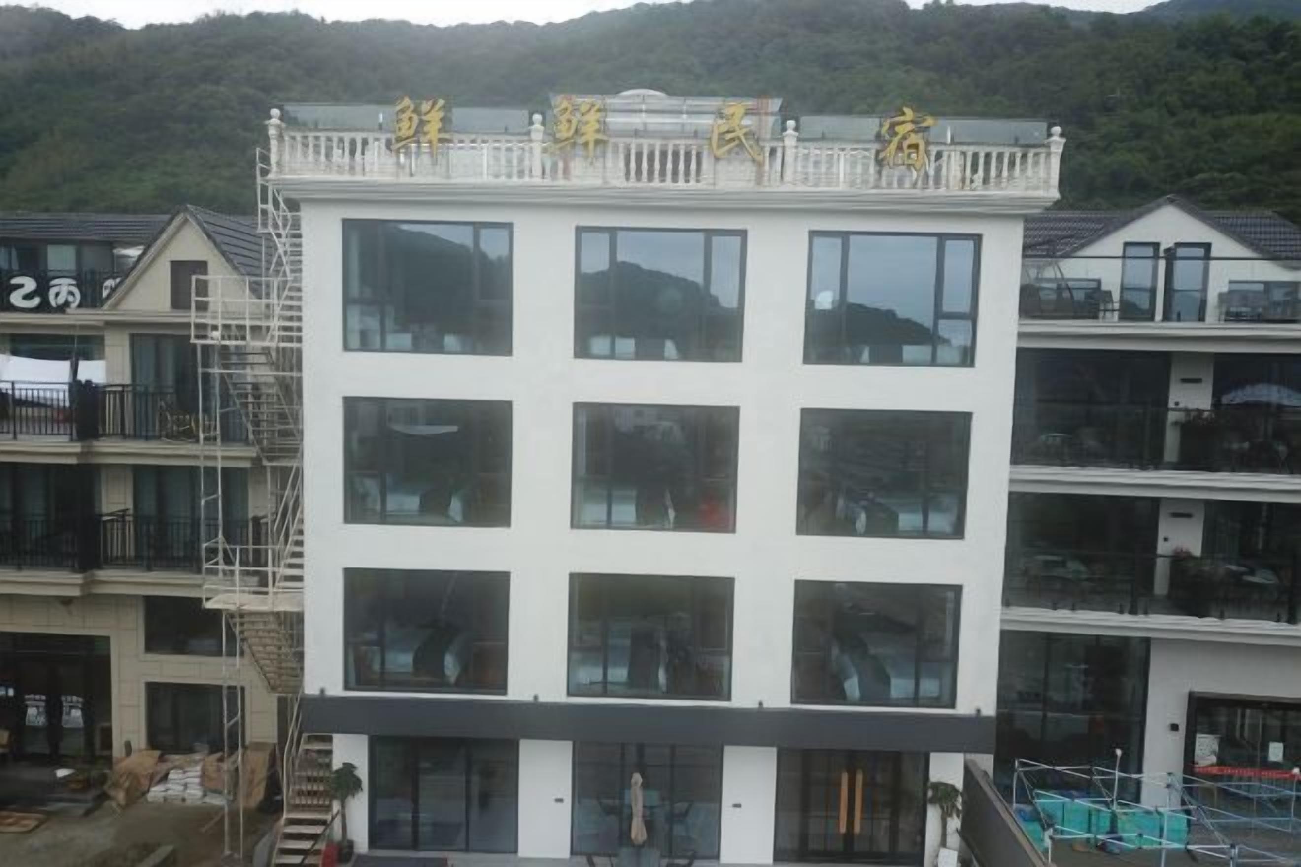A multi-story building with a balcony on the upper floor.