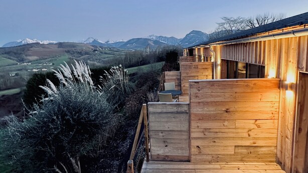 A wooden deck leading to a building with a view of snow-capped mountains. - Thoreau Suite - A Large Studio With Mountain Views (Aramits / Pyrénées Atlantiques)