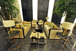 A lobby with a seating area, a coffee table, and two lamps. - Regao Hot Spring Hotel (Fushun)