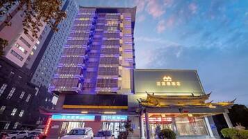 A hotel with a modern building and traditional Chinese architecture.