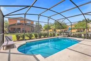 A swimming pool with a covered area, surrounded by a fence, and a bench.