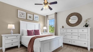 A bedroom with a white bed, two nightstands, a dresser, and a ceiling fan. - Last Minute Disney Getaway! Luxury Villa with Private Pool. Book Now! #65541 (Orlando)
