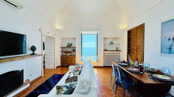 Deluxe Apartment, Sea View | Living area | 32-inch LED TV with digital channels