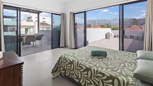 A bedroom with a bed, a desk, and a view of the outside. - Casa Bella Puerto Vallarta (Puerto Vallarta)