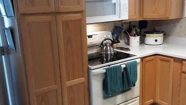 A kitchen with wooden cabinets, a microwave, a kettle, and a slow cooker. - Entire 2 bedroom home w/1 car garage in Inverness (Inverness)