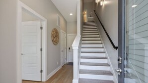 A staircase with a glass railing leading to an upper floor.
