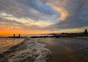 Guests can enjoy breathtaking ocean views from the shore, where waves gently lap against the rocks.