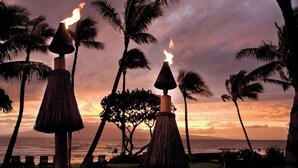 A sunset view with palm trees and tiki torches. - OceanFrnt-1BDRm/1 BATH-Marriott Lahaina/NapiliTower Maui-Full Resort-Real Owner (Lahaina)