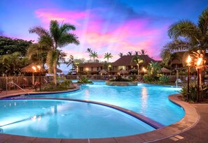 A resort pool area with multiple pools, palm trees, and thatched umbrellas. - Maui Kaanapali Villas Resort by KBM (Kaanapali)