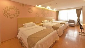 A hotel room with three beds, a sofa, and a chair. - GreenTree (Shuyang Development Zone Yingbin Avenue) (Shuyang)