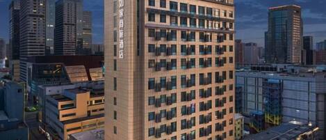 A high-rise hotel with multiple floors, large windows, and a modern architectural design.