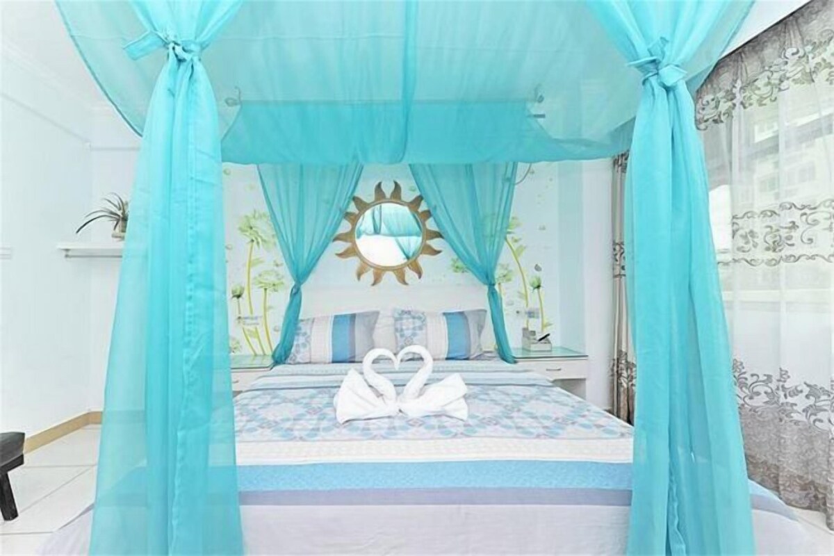 A bed with a canopy, a heart-shaped decoration, and a sun-shaped mirror on the headboard.