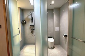 A modern bathroom with a glass partition, a shower, and a toilet. - Lugu Lake Yongzhen Hotel (Ninglang)
